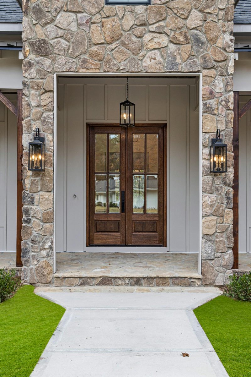Rustic wooden doors with stone facade and lanterns